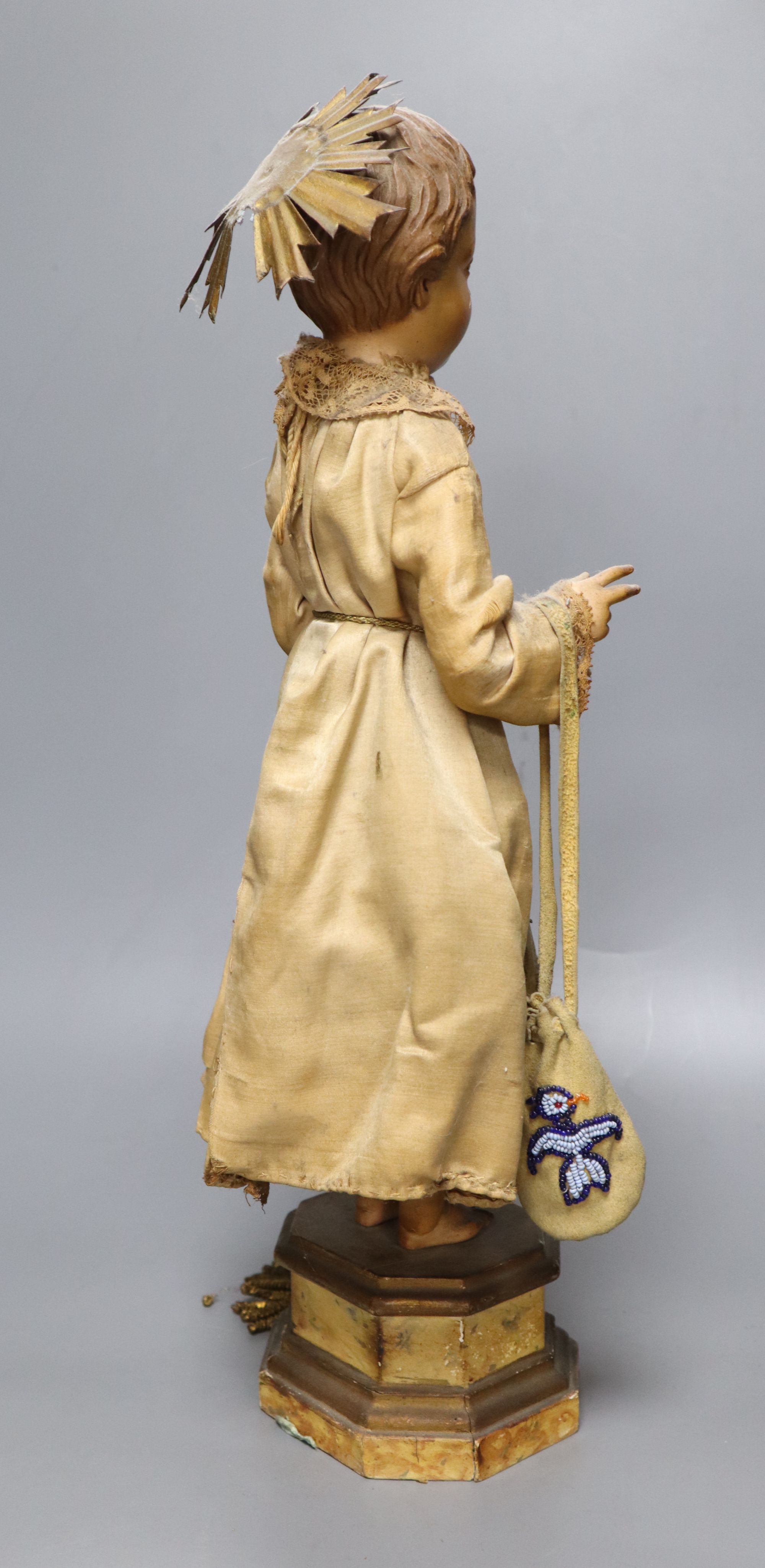 A late 19th century Continental carved and painted wood statue of a Saint, on a plinth base, height 49cm